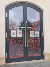 Remembrance Sunday: Covering glass door with poppies 